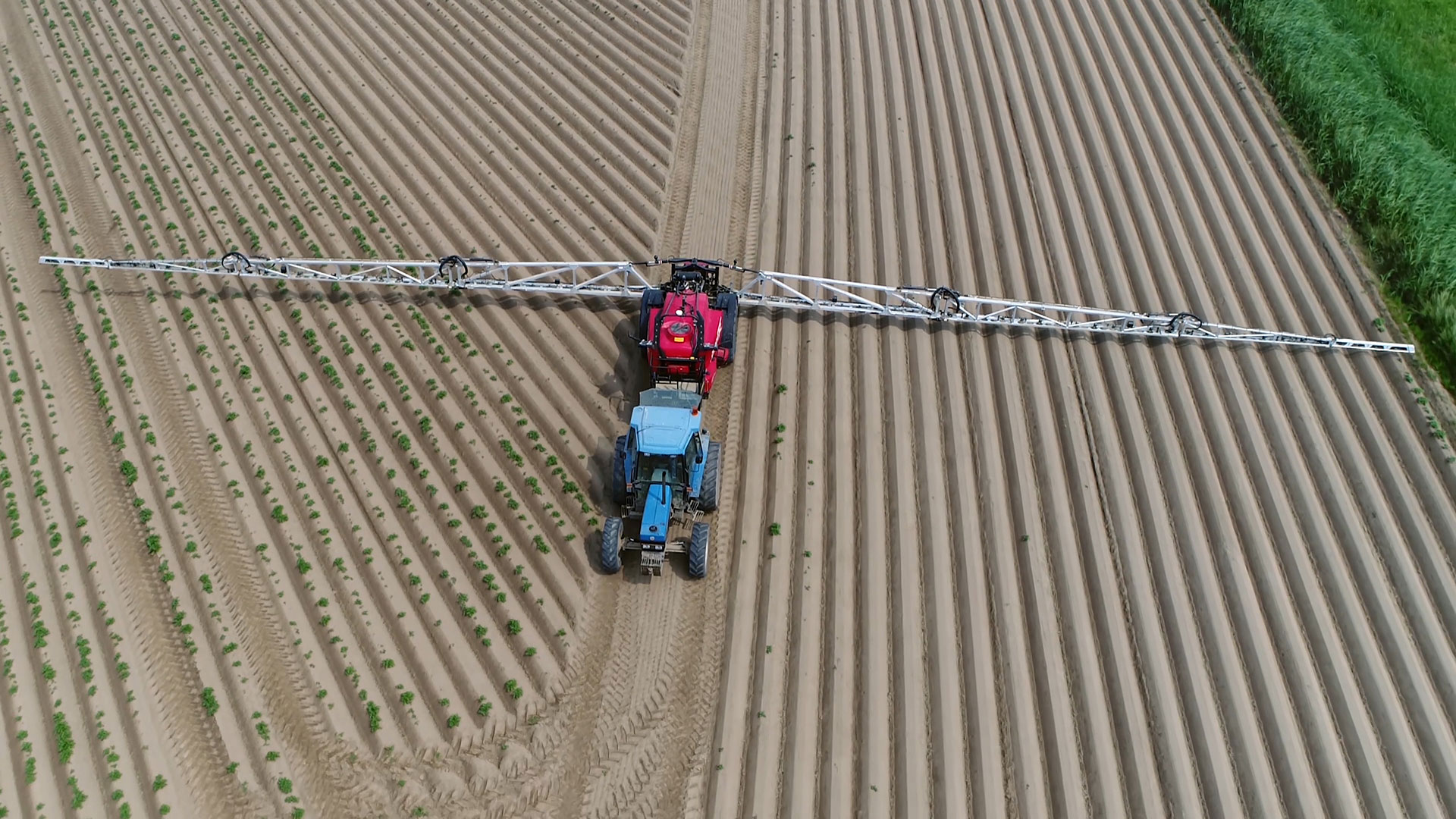 Aerial photo of tractor spraying herbicide on a field