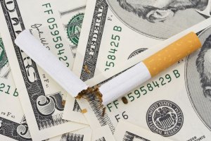 Broken cigarette on American dollar bills