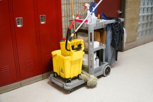 Janitorial supply cart in front of school lockers